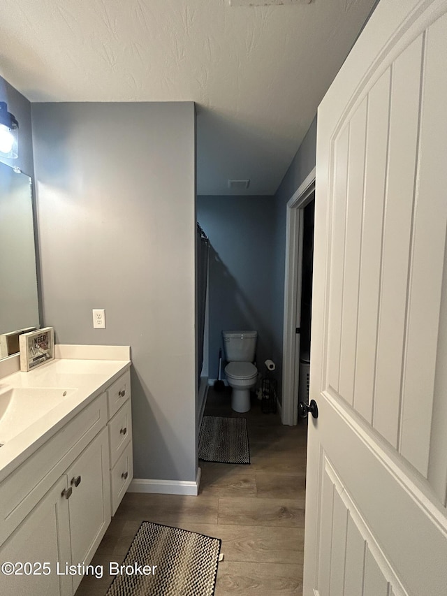 306 Oak Hill Ct, Bardstown, KY 40004 - bathroom with visible vents, toilet, a shower with shower curtain, wood finished floors, and vanity