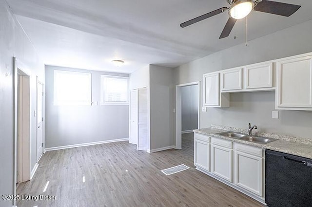 kitchen with light wood finished floors, dishwasher, light countertops, a ceiling fan, and a sink