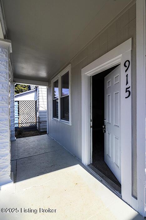 view of exterior entry with a porch