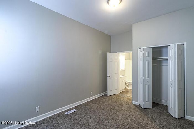 unfurnished bedroom with a closet, baseboards, visible vents, and dark carpet