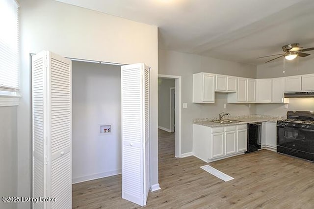 kitchen featuring light wood-style flooring, white cabinets, black appliances, a ceiling fan, and a sink