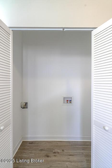 laundry room featuring washer hookup, laundry area, wood finished floors, and baseboards