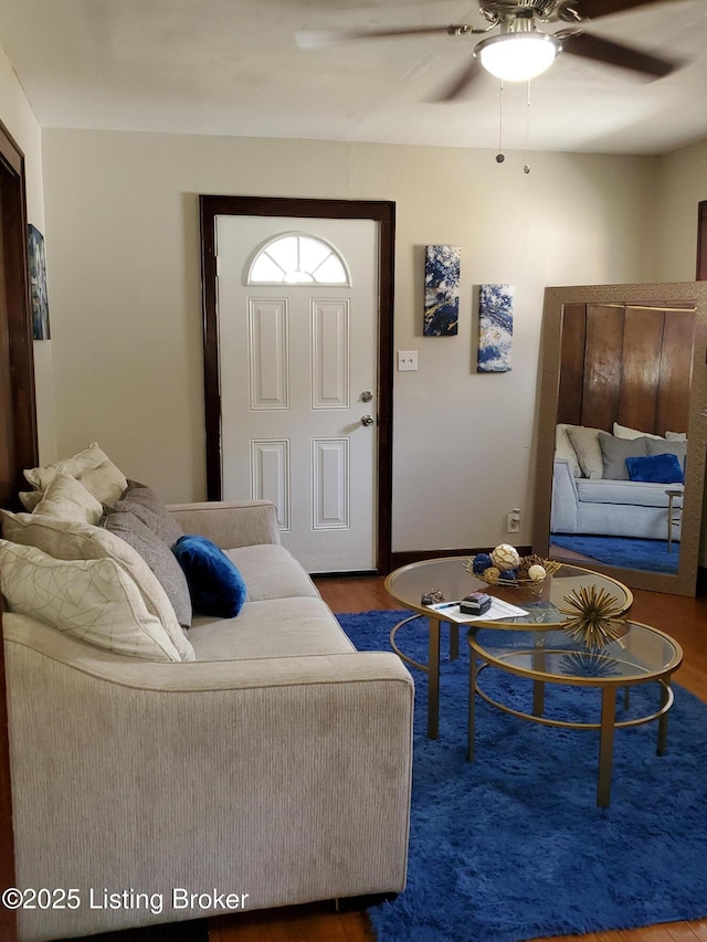 living area featuring a ceiling fan and wood finished floors