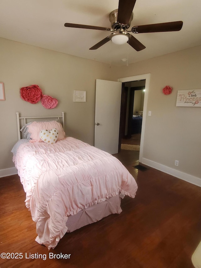 bedroom featuring ceiling fan, baseboards, and wood finished floors