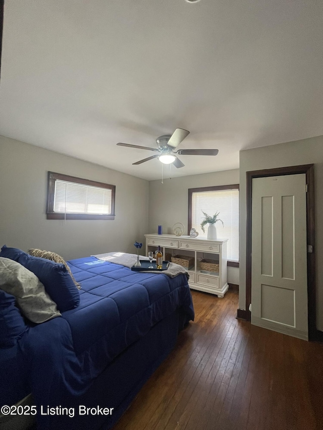 bedroom featuring a ceiling fan and dark wood-style flooring