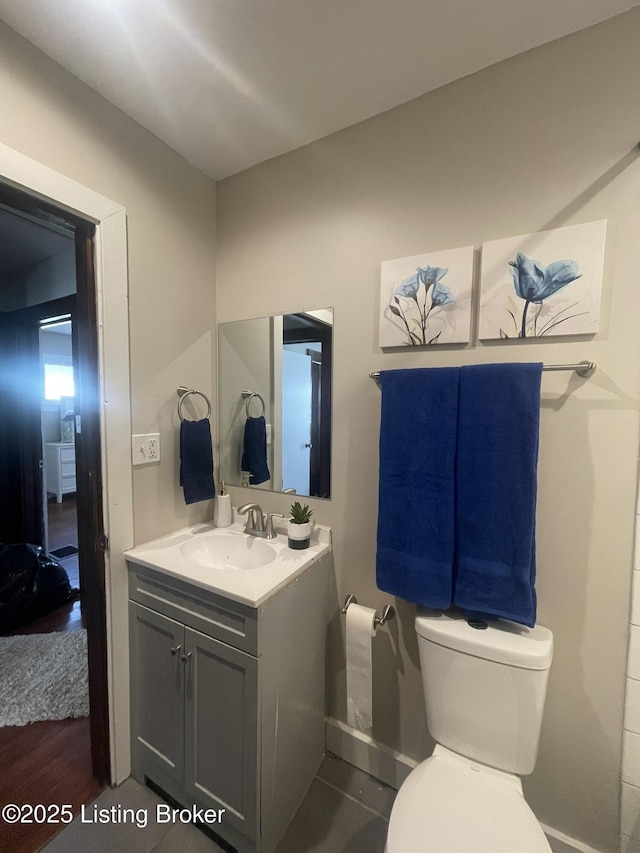 bathroom featuring vanity and toilet