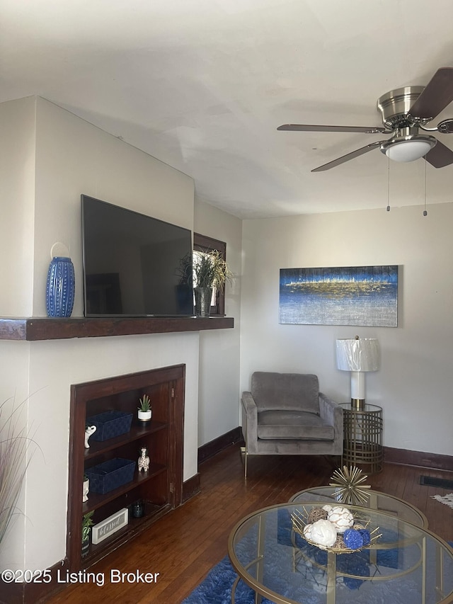 living room with wood finished floors, baseboards, and ceiling fan