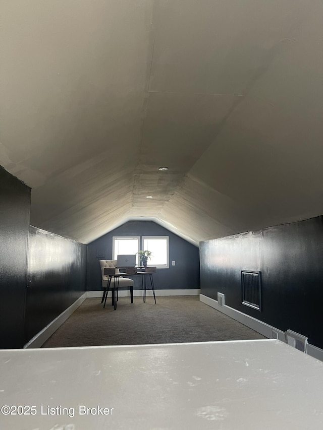 additional living space featuring lofted ceiling and baseboards