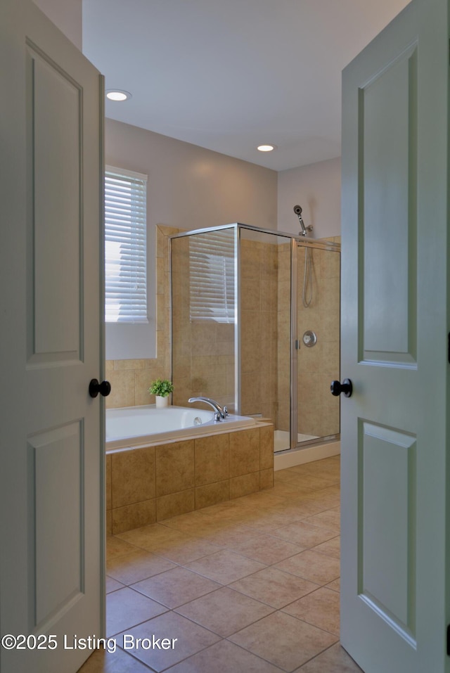 full bath with tile patterned floors, a garden tub, and a shower stall