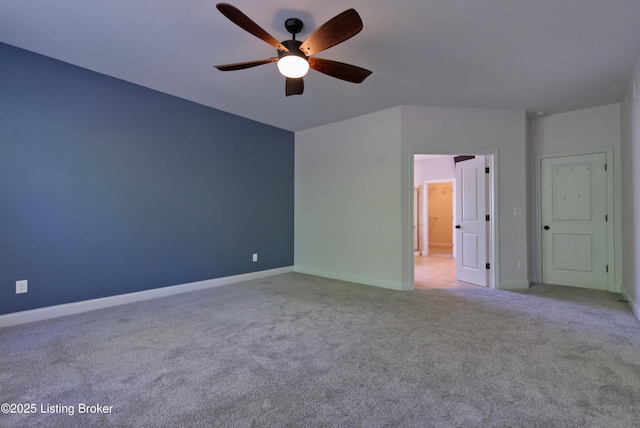 unfurnished room with a ceiling fan, light carpet, and baseboards