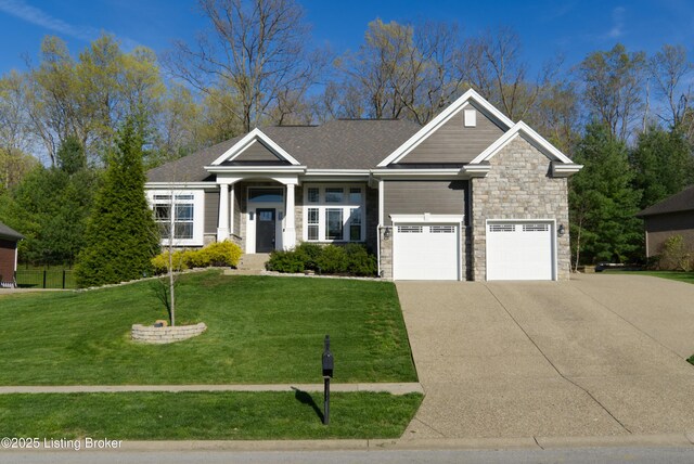 view of front of property with driveway, a front yard, and stone siding