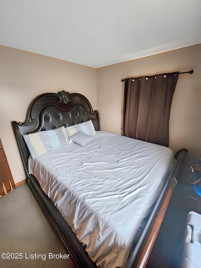 carpeted bedroom featuring baseboards