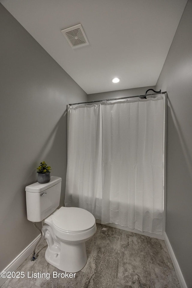 full bathroom with toilet, baseboards, and visible vents