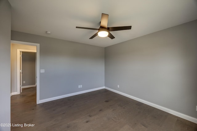 empty room with dark wood-style floors, baseboards, and ceiling fan