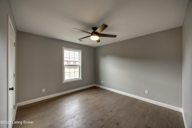 unfurnished room featuring visible vents, baseboards, dark wood-type flooring, and a ceiling fan