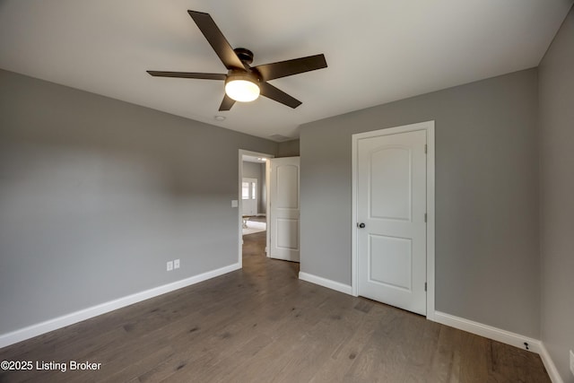 unfurnished bedroom with a ceiling fan, baseboards, and wood finished floors