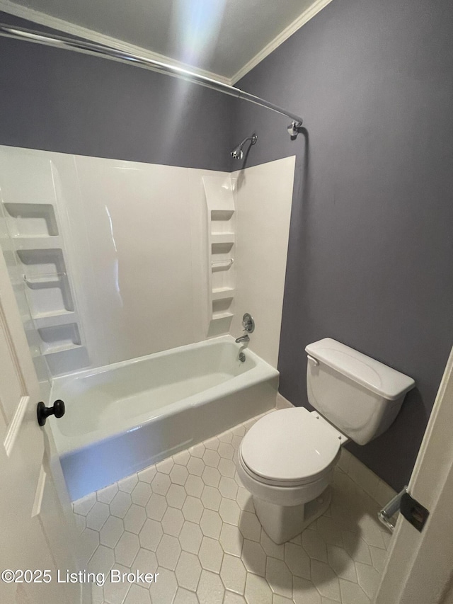 full bathroom featuring tile patterned flooring, toilet, and bathtub / shower combination