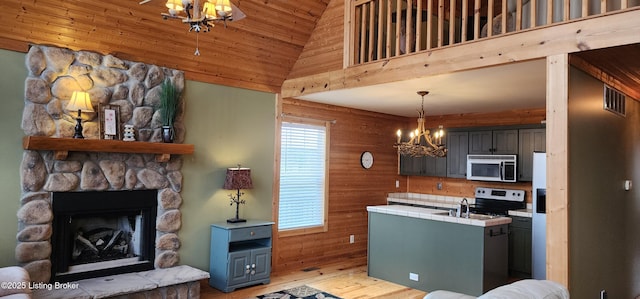 kitchen featuring visible vents, a notable chandelier, stainless steel microwave, electric range oven, and tile countertops