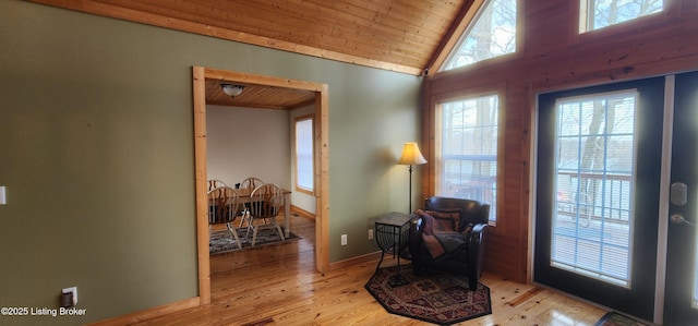 interior space with wood ceiling, light wood-style floors, baseboards, and high vaulted ceiling