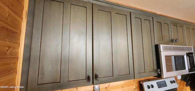 room details featuring washer / clothes dryer and gray cabinets