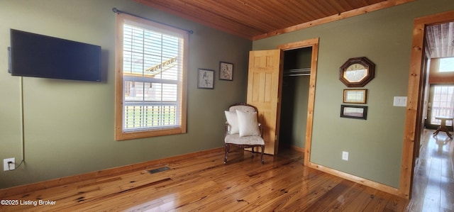 unfurnished room featuring wood ceiling, baseboards, and wood-type flooring