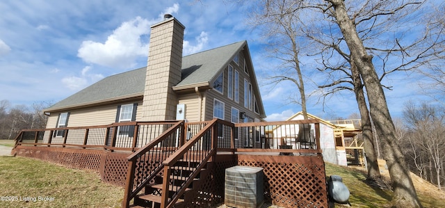 back of house with a deck, central AC unit, a chimney, and a shingled roof