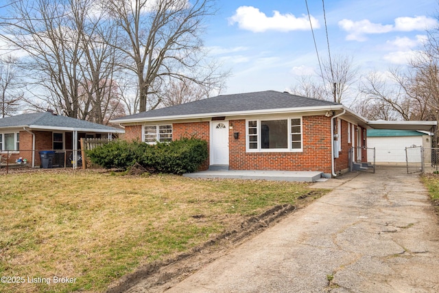 view of front of property with brick siding, concrete driveway, a front yard, and fence