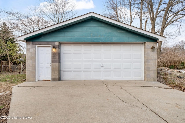 detached garage featuring fence