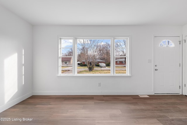 foyer featuring wood finished floors and baseboards