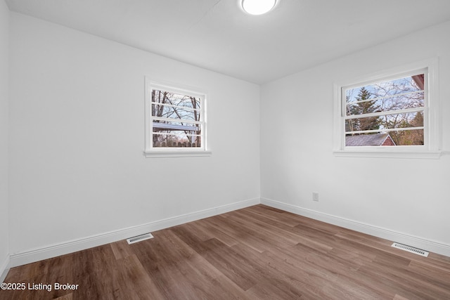 spare room with visible vents, baseboards, and a healthy amount of sunlight