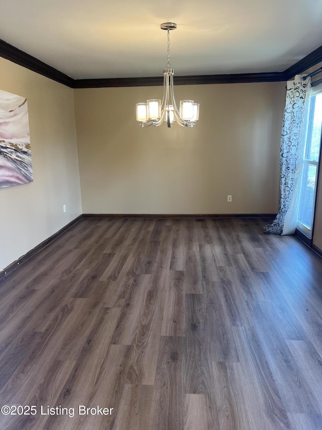 unfurnished dining area featuring an inviting chandelier, dark wood-style floors, crown molding, and baseboards