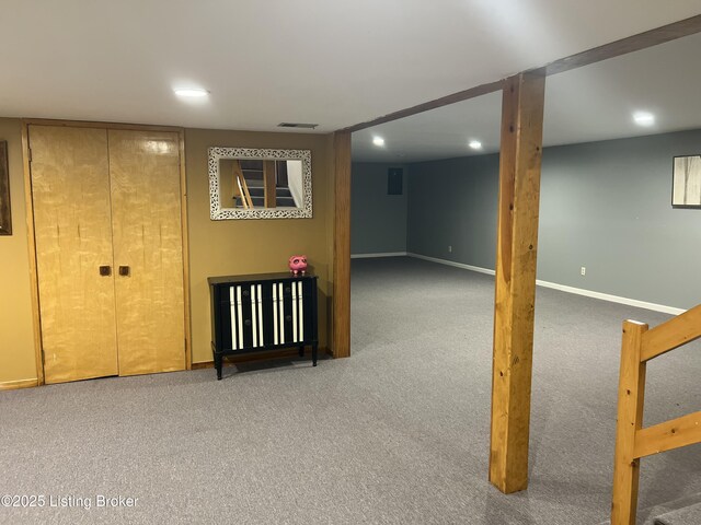 finished below grade area featuring visible vents, recessed lighting, baseboards, and carpet