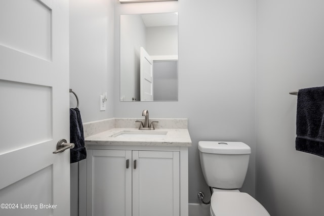 half bath featuring toilet and vanity