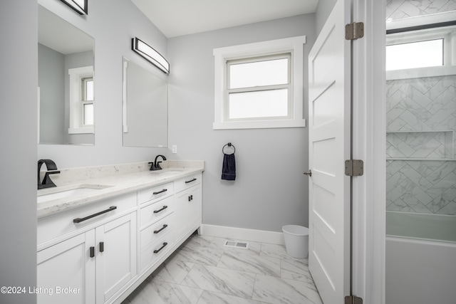 full bathroom featuring visible vents, baseboards, double vanity, marble finish floor, and a sink