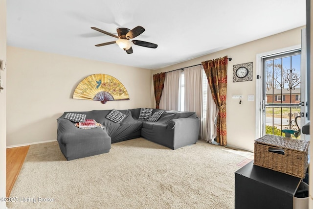 living room featuring a wealth of natural light, baseboards, and ceiling fan