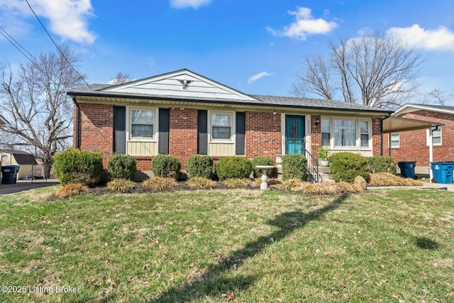 ranch-style home featuring brick siding, a carport, and a front lawn