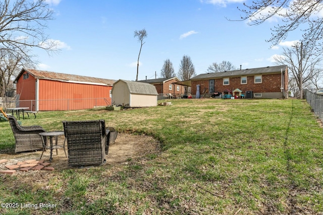 view of yard featuring an outdoor structure, a shed, and fence