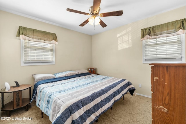 carpeted bedroom with a ceiling fan and baseboards