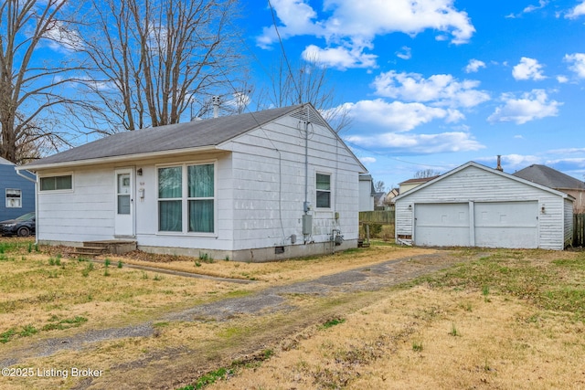 view of front of house featuring an outdoor structure, a garage, driveway, and crawl space