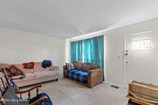 living room featuring visible vents, a healthy amount of sunlight, and carpet floors