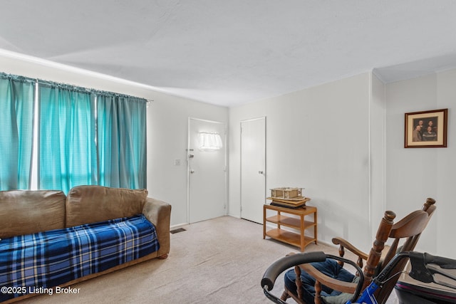 carpeted living area featuring visible vents