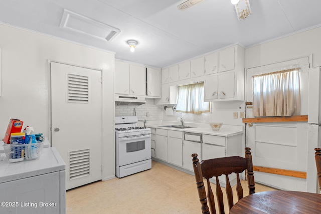 kitchen with under cabinet range hood, a sink, light floors, white cabinetry, and white range with gas stovetop