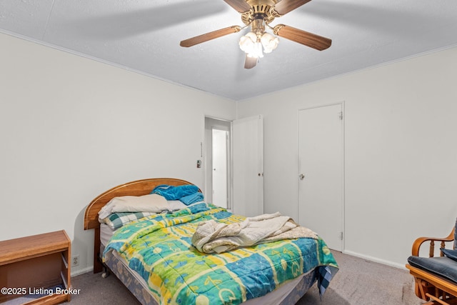 bedroom with a ceiling fan, baseboards, carpet floors, and ornamental molding