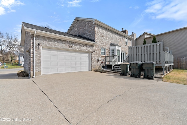 view of property exterior with a garage, brick siding, and concrete driveway