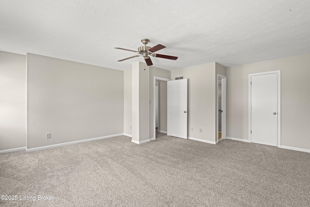 unfurnished bedroom featuring baseboards, carpet floors, and a textured ceiling