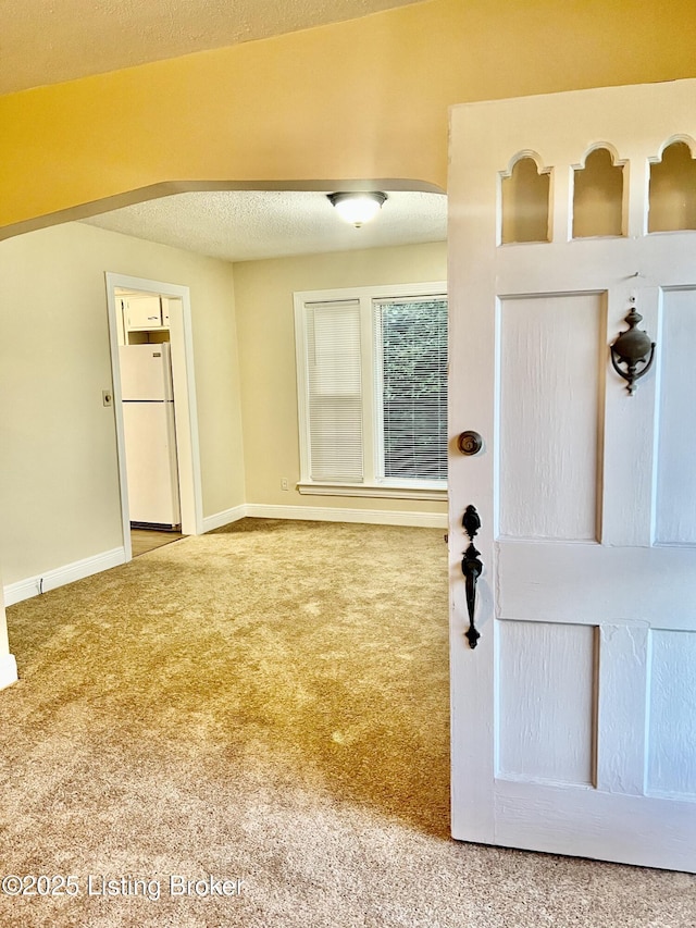 interior space with baseboards and a textured ceiling