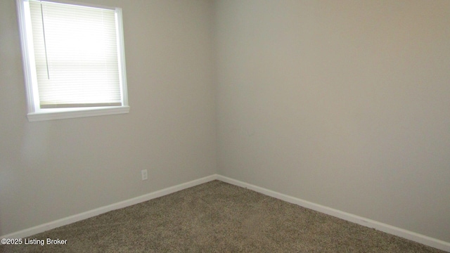 carpeted spare room with baseboards