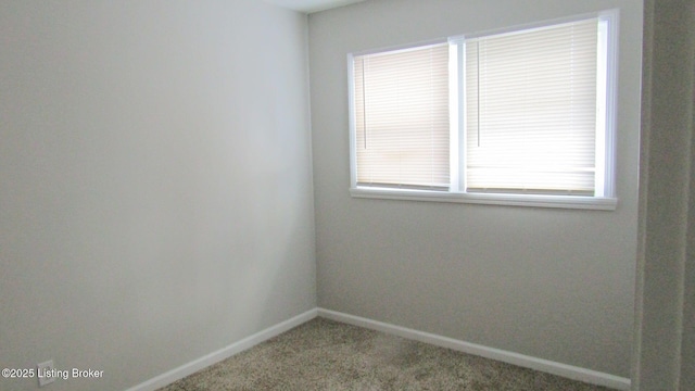 carpeted empty room with baseboards