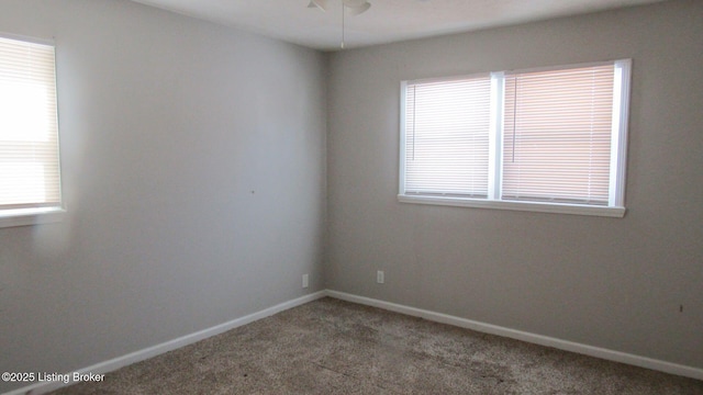 spare room featuring carpet flooring, ceiling fan, and baseboards