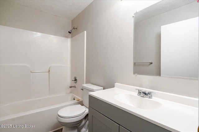 full bath featuring vanity, toilet, shower / bathtub combination, and a textured ceiling